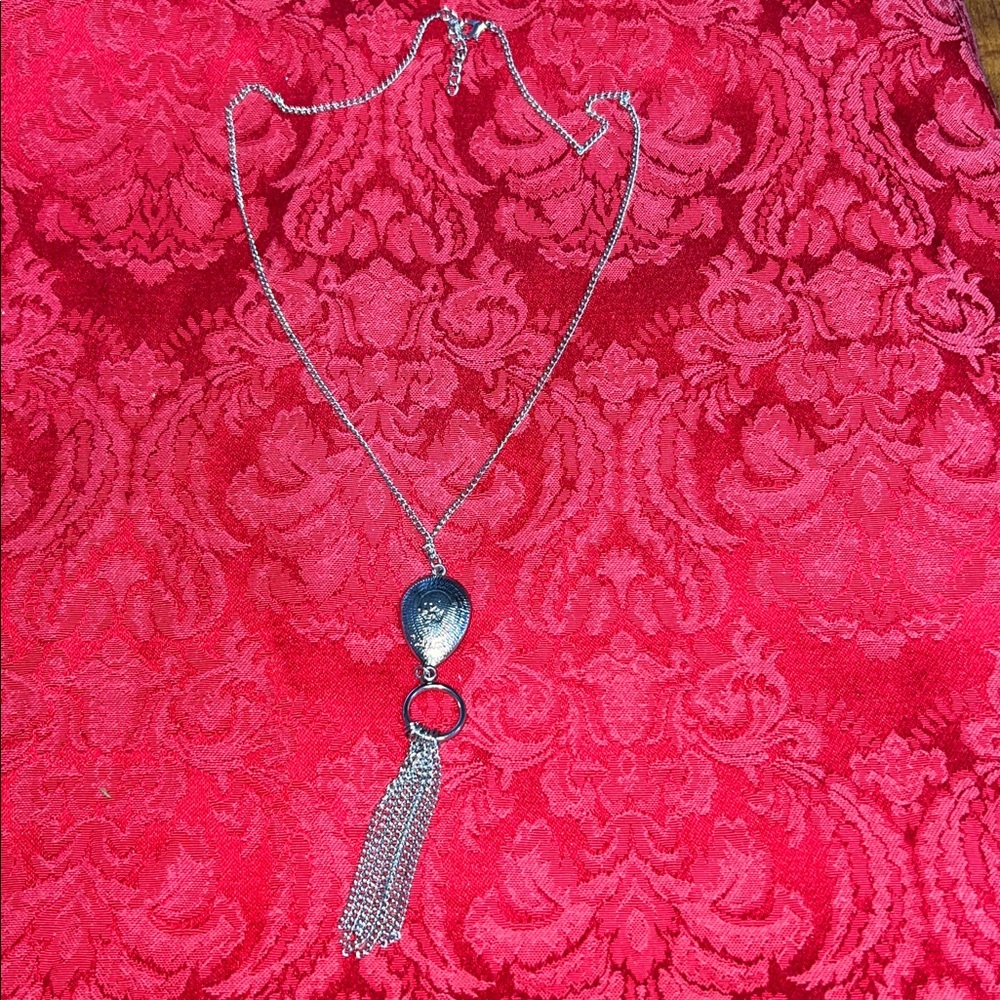 Silver-tone pendant w/chain tassel drop. Etched silver tone/or white